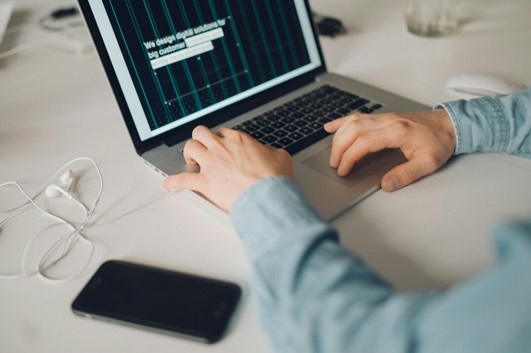 student writing code on laptop