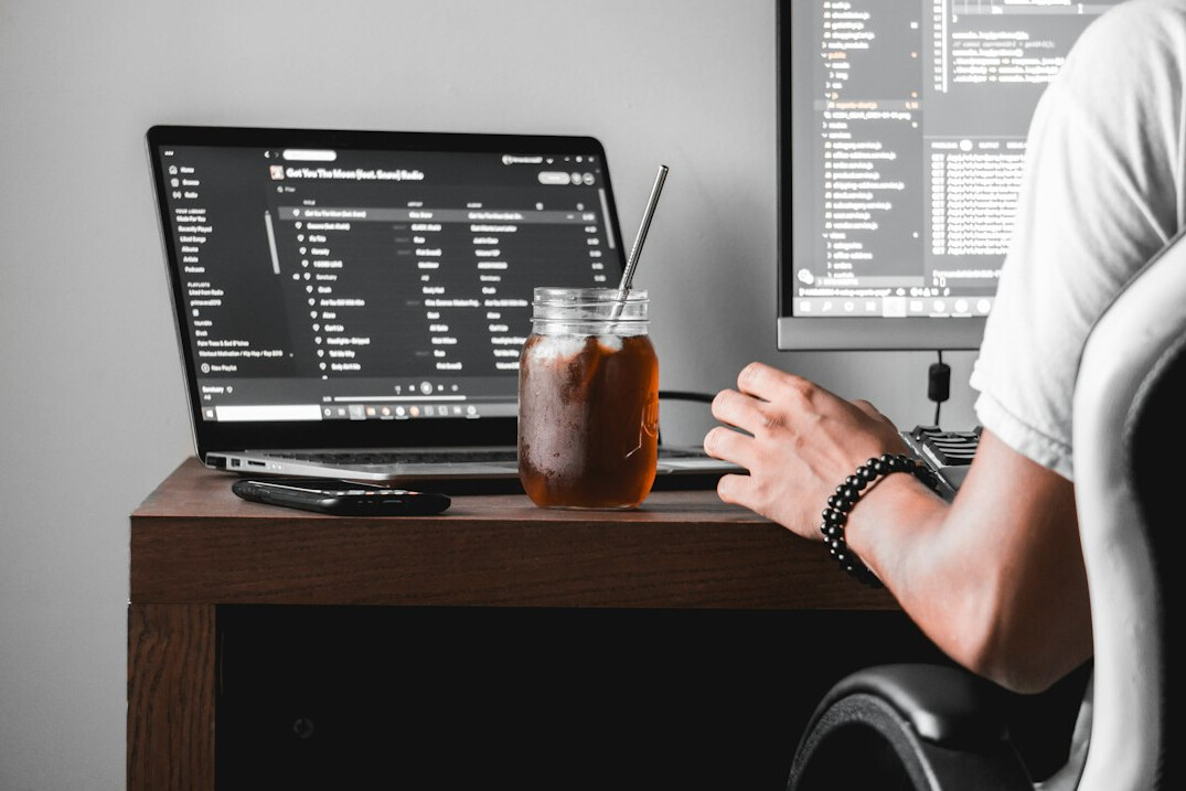 person coding at desk